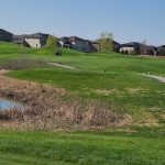 Panoramic view of a lush green golf course at Osgood Golf Course. Smooth