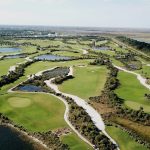 Panoramic view of a lush green golf course at Osprey Point Golf Course. Smooth