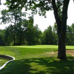 Panoramic view of a lush green golf course at Otter Creek Golf Course. Smooth