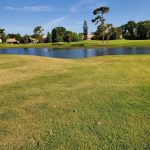 Panoramic view of a lush green golf course at Oyster Creek Golf Club. Smooth