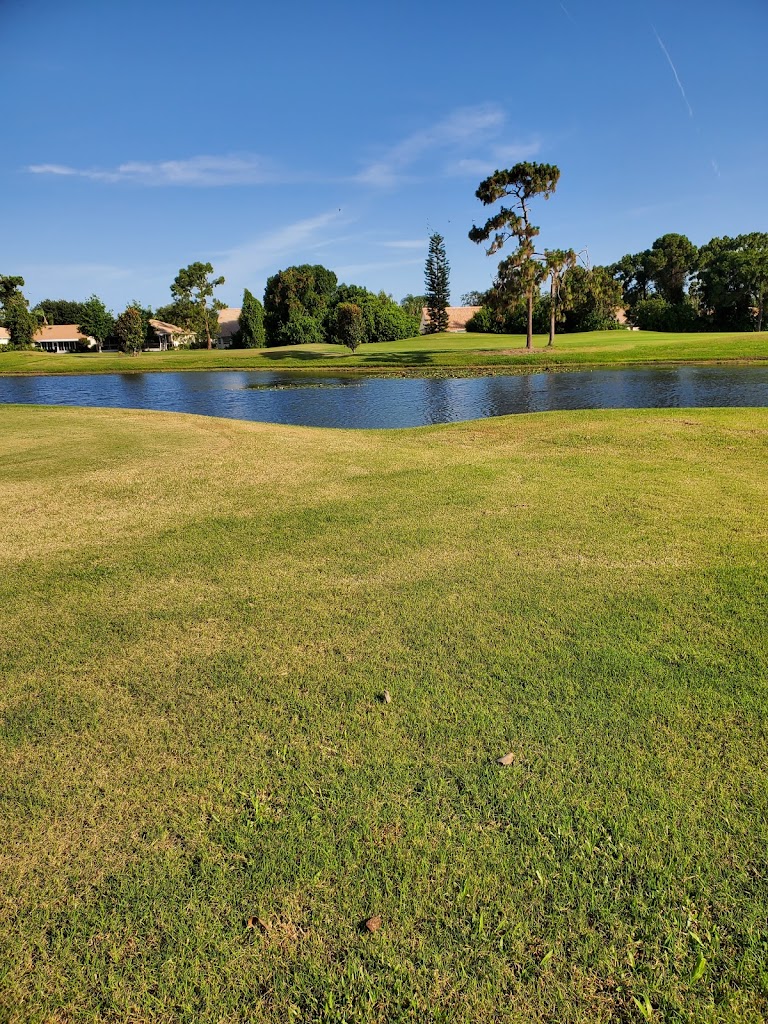 Panoramic view of a lush green golf course at Oyster Creek Golf Club. Smooth