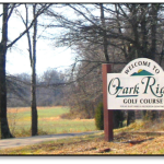 Panoramic view of a lush green golf course at Ozark Ridge Golf Course. Smooth