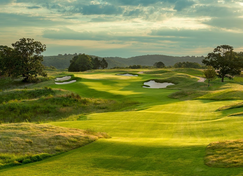Panoramic view of a lush green golf course at Ozarks National Golf Course. Smooth