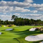 Panoramic view of a lush green golf course at PGA Golf Club at PGA Village. Smooth