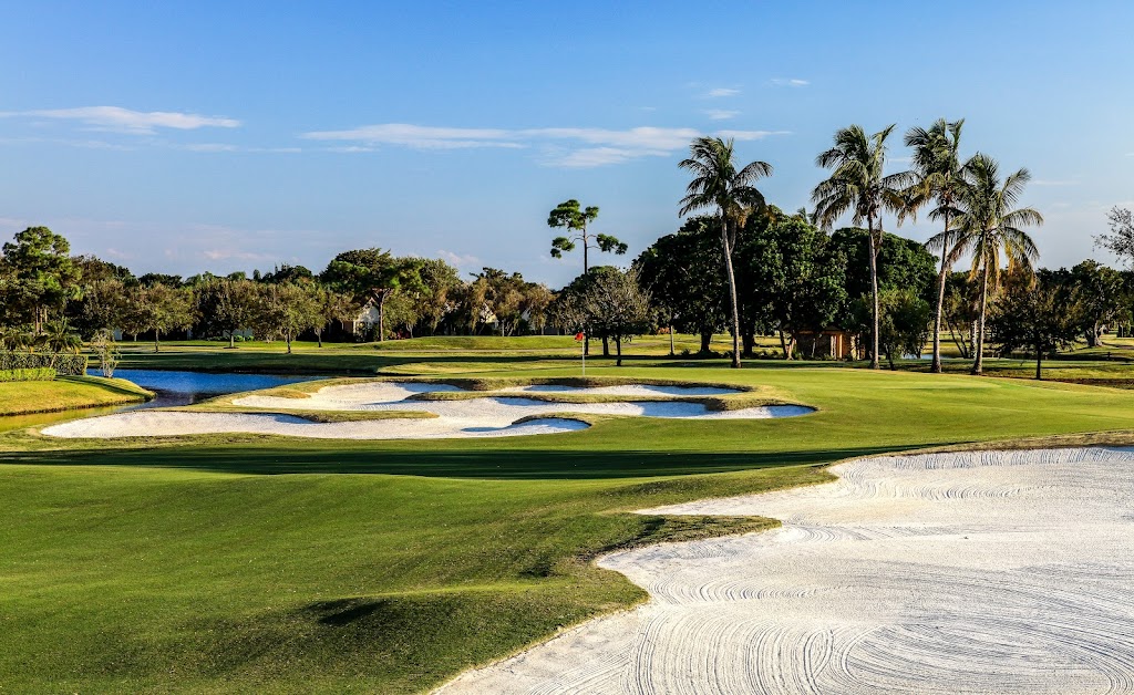 Panoramic view of a lush green golf course at PGA National Members Club. Smooth