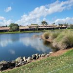 Panoramic view of a lush green golf course at PGA National Members Club. Smooth