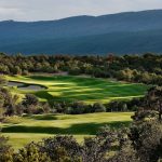 Panoramic view of a lush green golf course at Paako Ridge Golf Club. Smooth