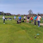 green grass with the flag in the hole.