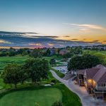 Panoramic view of a lush green golf course at Pacific Springs Golf Course. Smooth