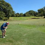 Panoramic view of a lush green golf course at Page Belcher Golf Course. Smooth