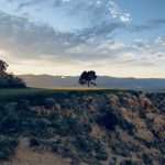 Panoramic view of a lush green golf course at Palisade Golf Course. Smooth