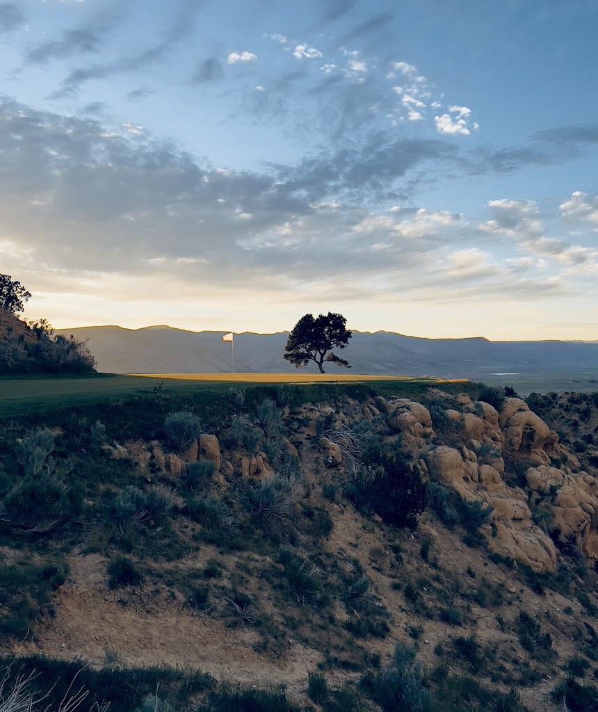 Panoramic view of a lush green golf course at Palisade Golf Course. Smooth