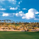 Panoramic view of a lush green golf course at Palm Valley Golf Club. Smooth