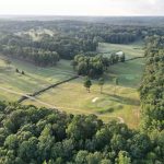 Panoramic view of a lush green golf course at Panola Mountain Golf Course. Smooth