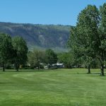 Panoramic view of a lush green golf course at Paradise Valley Country Club. Smooth