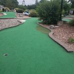 green grass with the flag in the hole.