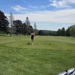 Panoramic view of a lush green golf course at Paris Hill Country Club. Smooth