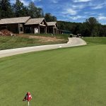 Panoramic view of a lush green golf course at Park Mammoth Golf Club. Smooth