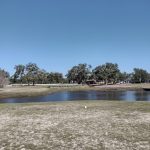 Panoramic view of a lush green golf course at Pass Christian Isles Golf Club. Smooth