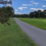 Panoramic view of a lush green golf course at Passaconaway Country Club. Smooth