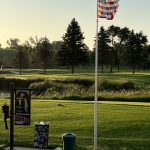 green grass with the flag in the hole.