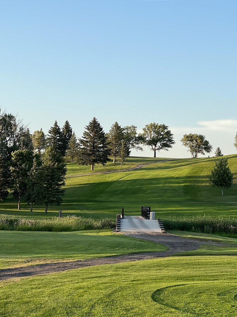 Panoramic view of a lush green golf course at Peaceful Valley Golf Course. Smooth