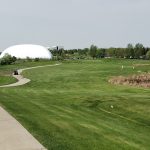 green grass with the flag in the hole.