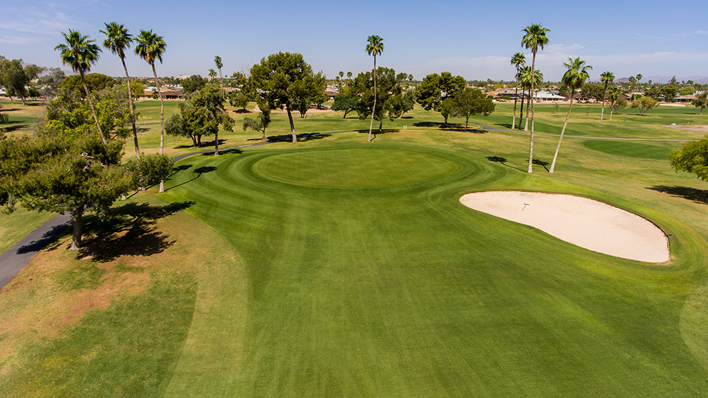 Panoramic view of a lush green golf course at Pebblebrook Golf Course. Smooth