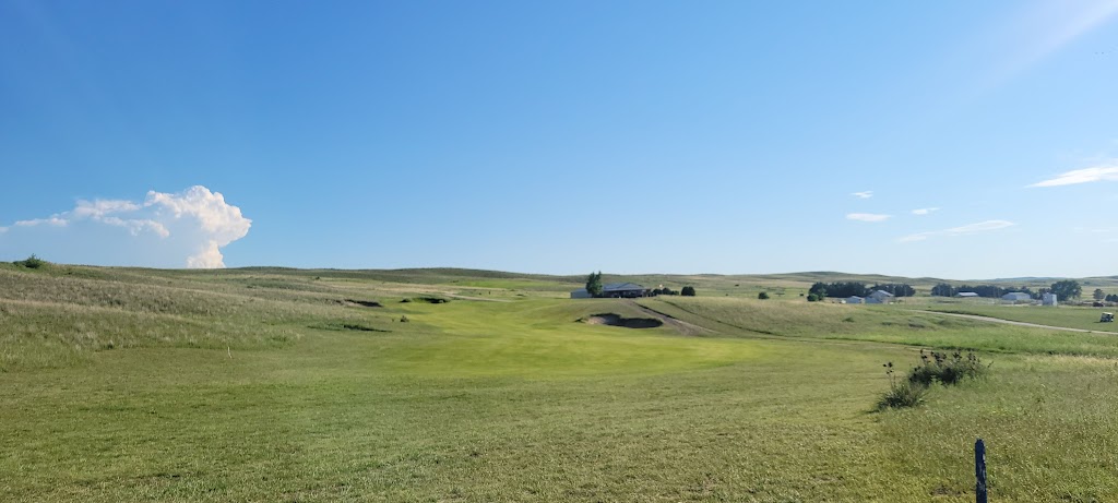 Panoramic view of a lush green golf course at Pelican Beach Golf Course. Smooth