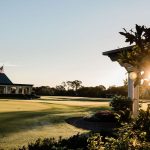 Panoramic view of a lush green golf course at Pelican Golf Club. Smooth