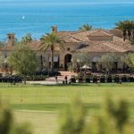 Panoramic view of a lush green golf course at Pelican Hill Golf Club. Smooth