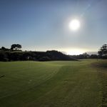 Panoramic view of a lush green golf course at Pelican Hill Golf Club. Smooth