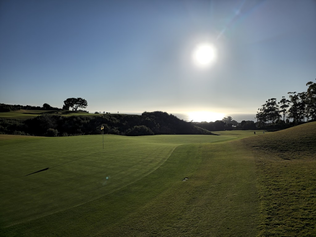 Panoramic view of a lush green golf course at Pelican Hill Golf Club. Smooth