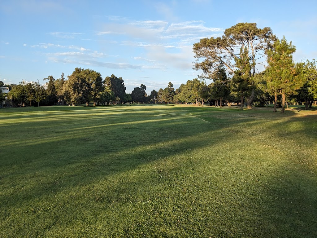 Panoramic view of a lush green golf course at Penmar Golf Course. Smooth
