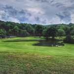 Panoramic view of a lush green golf course at Pennyrile Forest State Resort Park Golf Course. Smooth