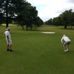 green grass with the flag in the hole.