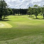 Panoramic view of a lush green golf course at Percy Warner Golf Course. Smooth