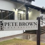 Panoramic view of a lush green golf course at Pete Brown Golf Facility. Smooth