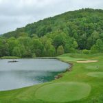 Panoramic view of a lush green golf course at Pete Dye Golf Club. Smooth