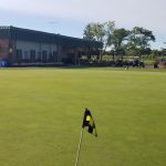 green grass with the flag in the hole.