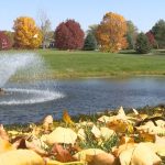 Panoramic view of a lush green golf course at Pheasant Ridge Golf Course. Smooth