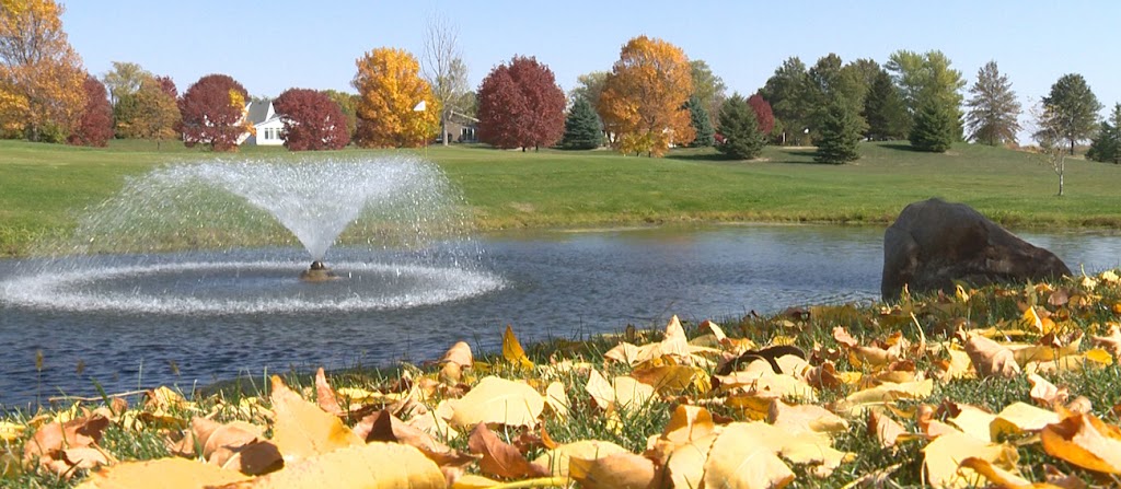 Panoramic view of a lush green golf course at Pheasant Ridge Golf Course. Smooth