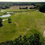 Panoramic view of a lush green golf course at Piankatank River Golf Course. Smooth