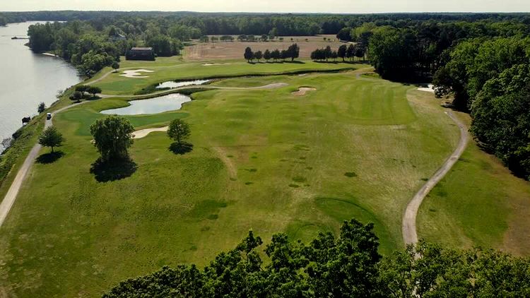 Panoramic view of a lush green golf course at Piankatank River Golf Course. Smooth
