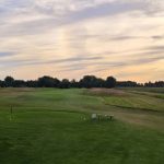 Panoramic view of a lush green golf course at Pigeon Creek Golf Course. Smooth
