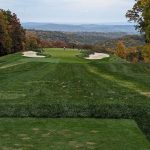 Panoramic view of a lush green golf course at Pikewood National Golf Club. Smooth