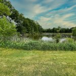 Panoramic view of a lush green golf course at Pinch Brook Golf Course. Smooth