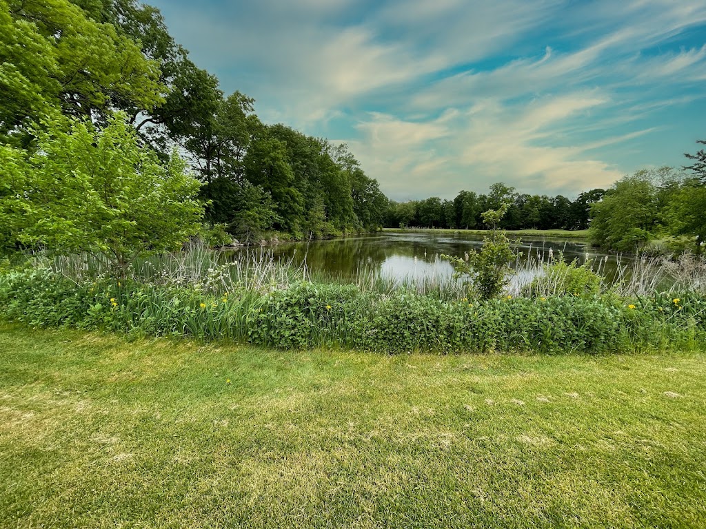 Panoramic view of a lush green golf course at Pinch Brook Golf Course. Smooth