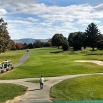Panoramic view of a lush green golf course at Pine Hills Country Club. Smooth