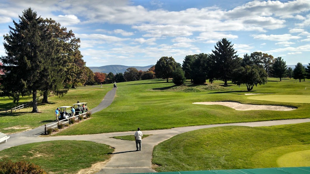 Panoramic view of a lush green golf course at Pine Hills Country Club. Smooth